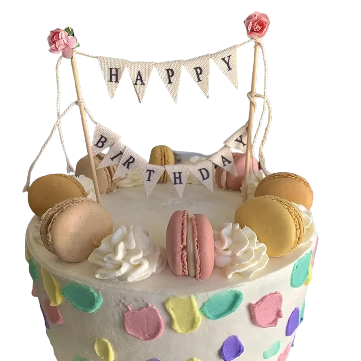 A pastel happy birthday cake with colorful macarons white frosting swirls and a bunting topper with pink roses