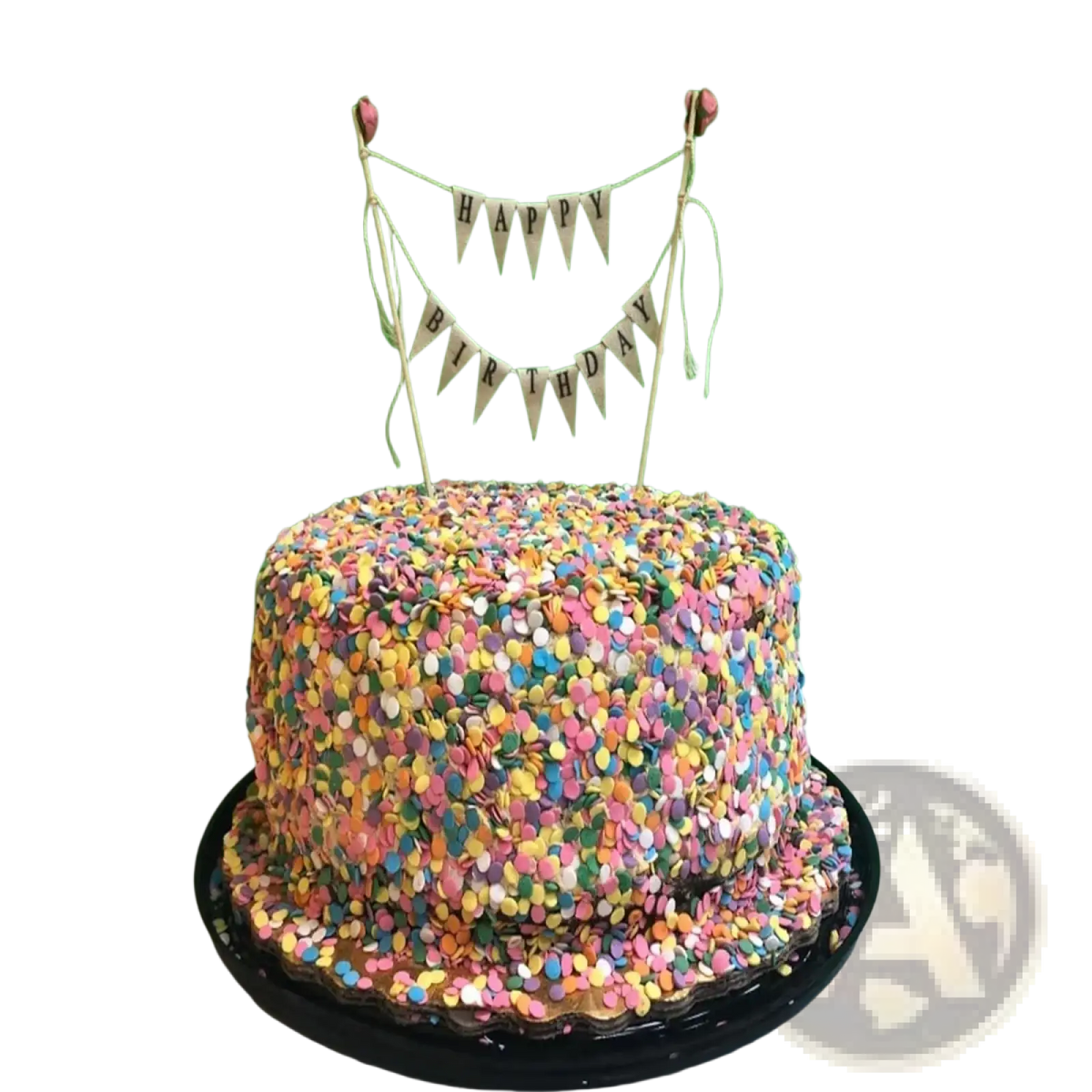 A round happy birthday cake with colorful confetti and a pink rose bunting topper for birthday celebrations