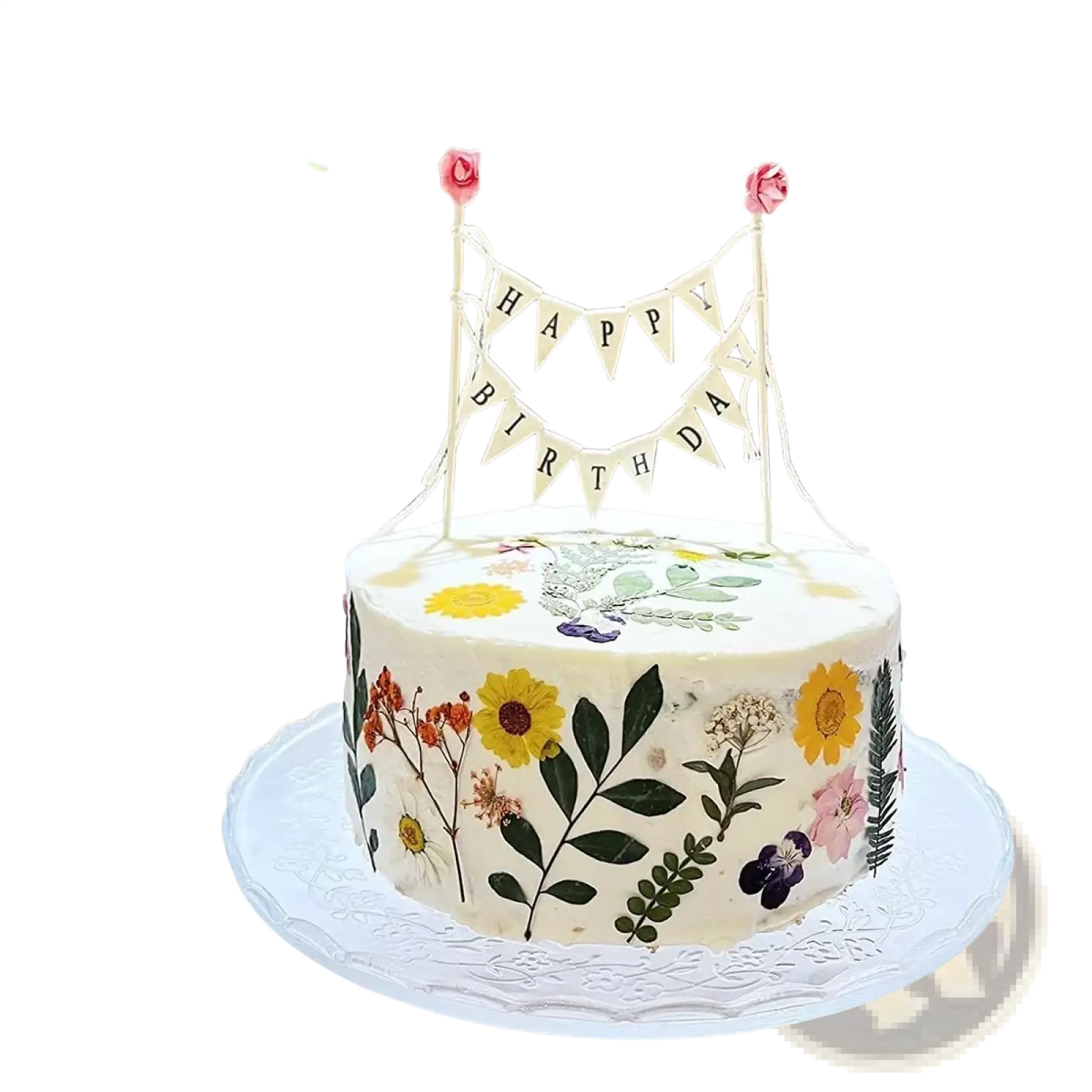 A white birthday cake with a happy birthday cake bunting topper and pressed yellow pink and purple flowers