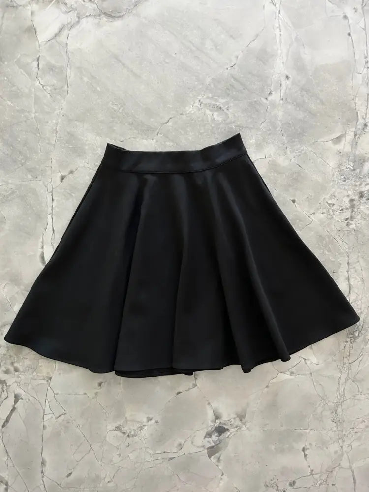 Harper black pleated skater skirt with satin finish elastic waistband and pockets for comfortable wear