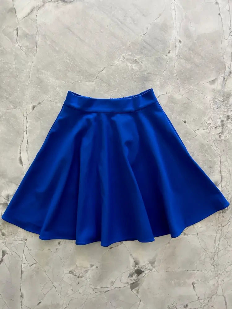 A vibrant royal blue high waisted pocket skater skirt with a smooth satin finish and flared design