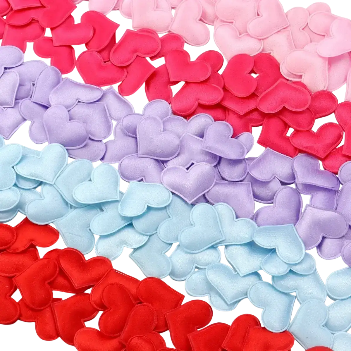 A collection of soft plush heart confetti in red pink lavender and light blue for valentine parties table decor