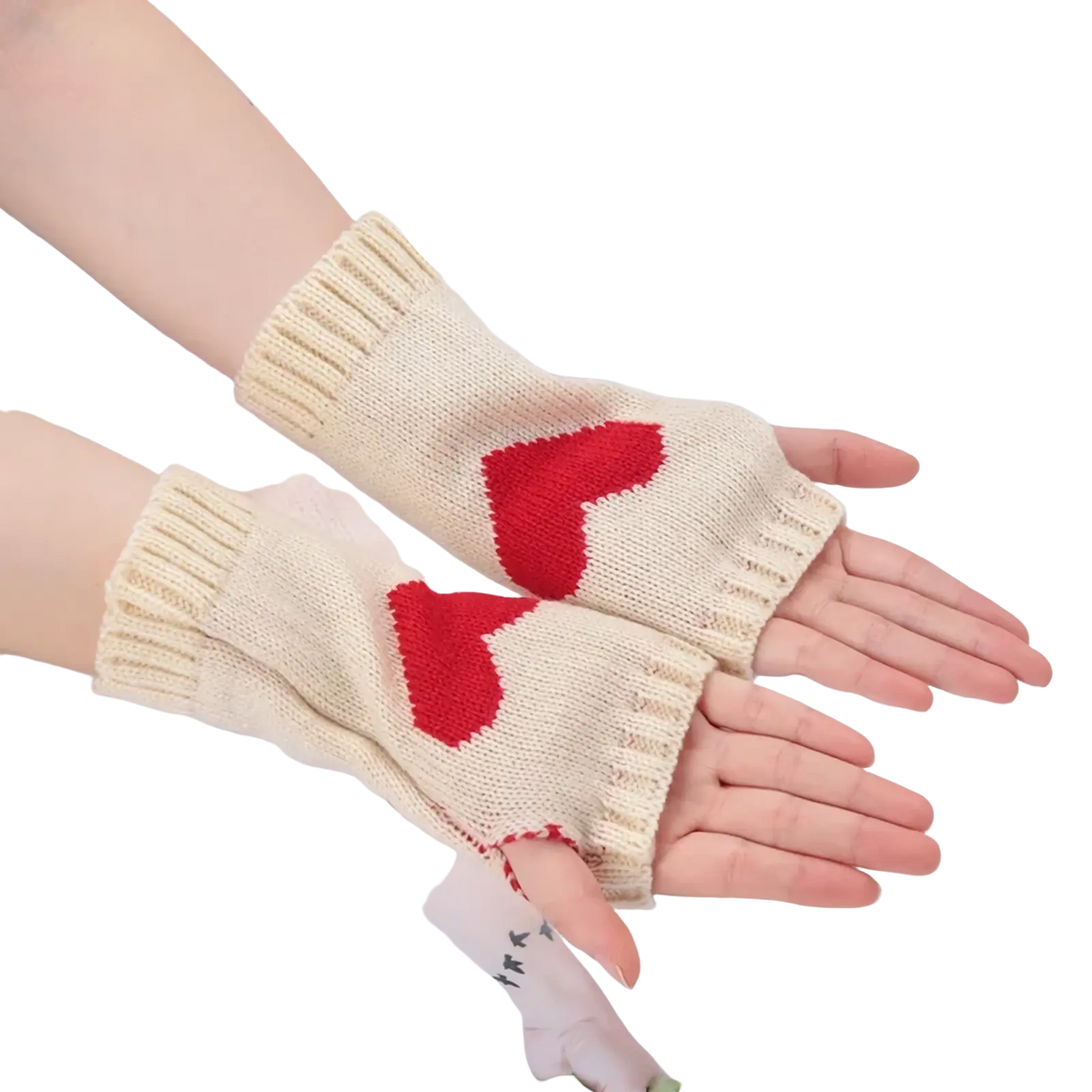 Cream-colored knitted fingerless gloves with red heart designs featuring a cozy arm warmer style
