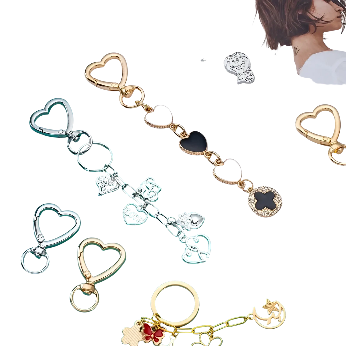 A gold-toned heart keychain with white and black enamel hearts and intricate metal charms clasp ring design