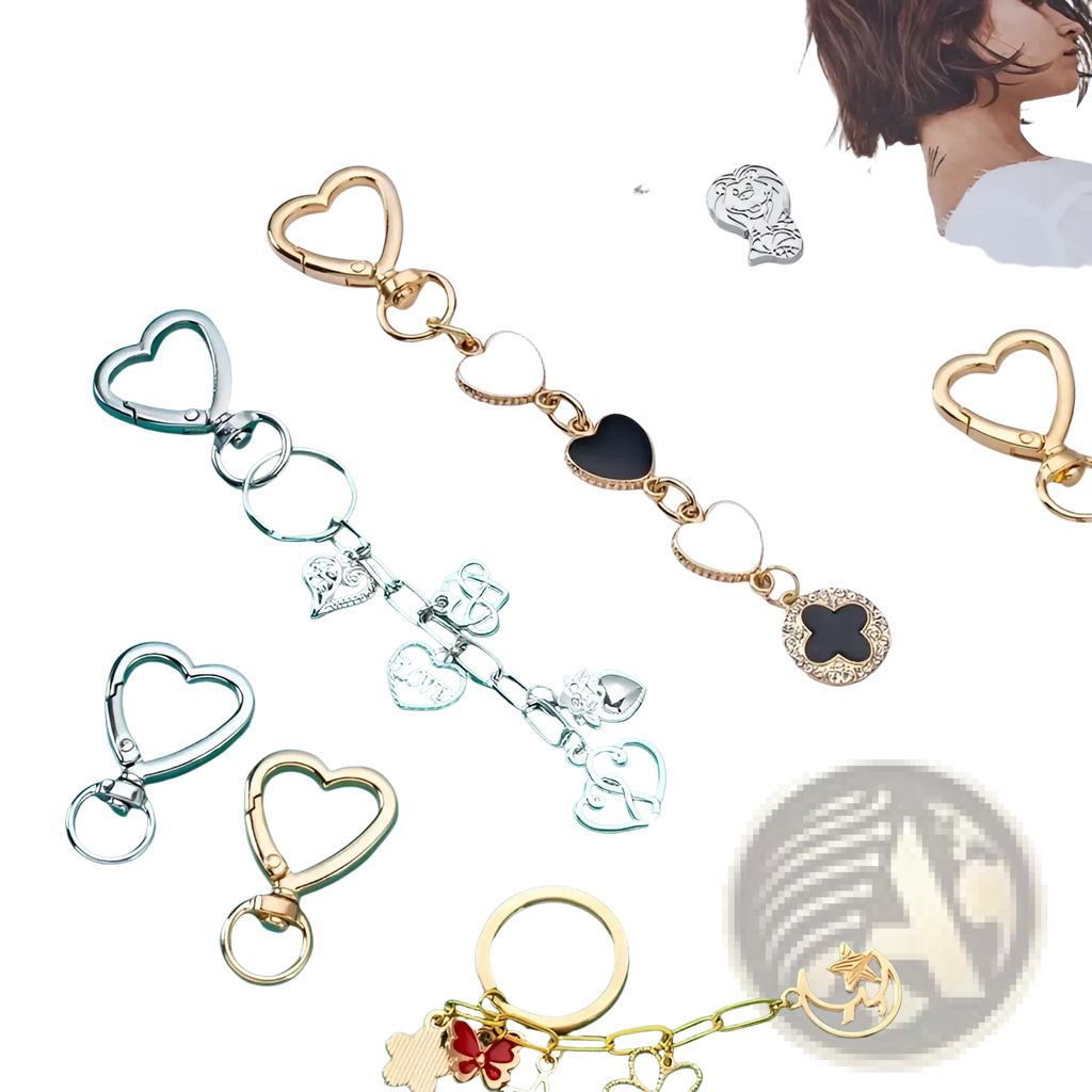 A gold-toned heart keychain with white and black enamel hearts and intricate metal charms clasp ring design