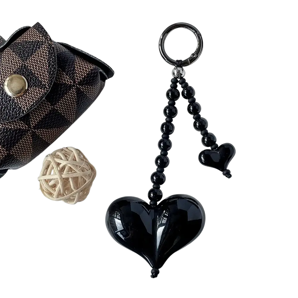 Black glossy heart keychain with a beaded chain and smaller matching heart pendant for bag charm use