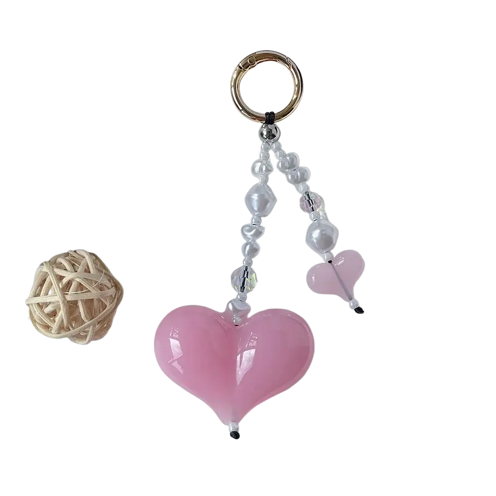 A pink heart keychain beaded bag charm with clear and pearl-like beads and a gold-toned metal ring