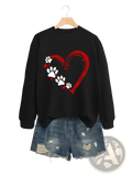 Black long-sleeved pullover hoodie with red heart design featuring white paw prints and small red hearts