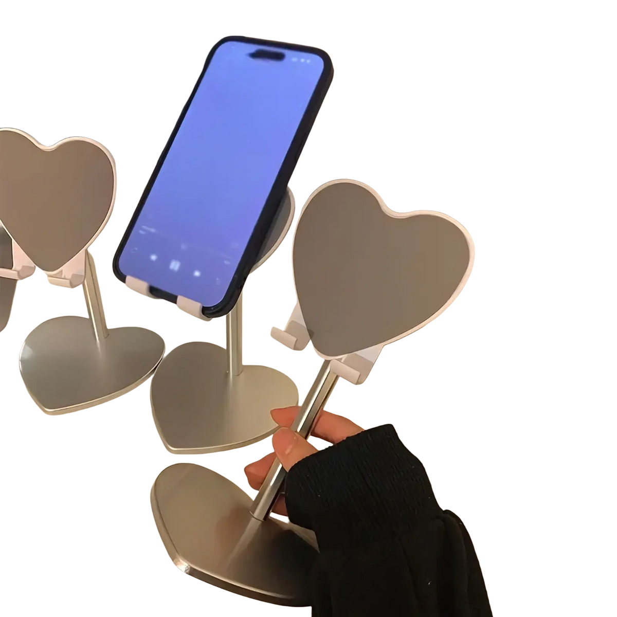 Silver heart shaped adjustable phone stand made of metal holding a smartphone on a desktop holder