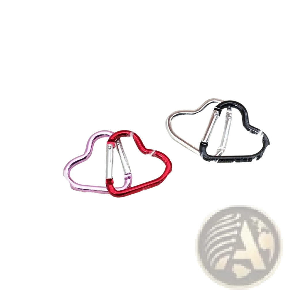 Heart shaped carabiner keychain set with pink red and black metallic finishes on a white fluffy surface