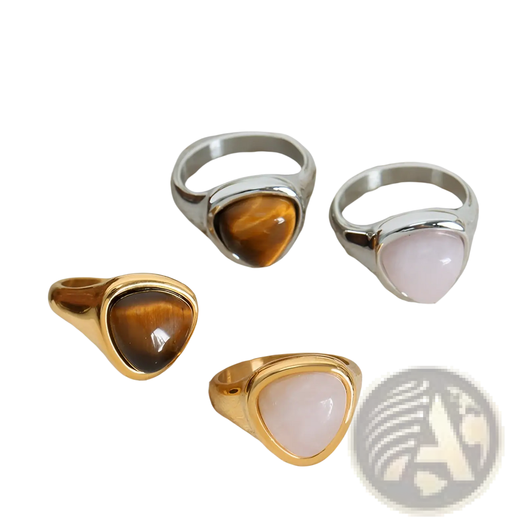 Set of four statement rings with triangular tiger eye and rose quartz stones in gold and silver titanium steel settings