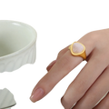Gold ring with a soft pink heart-shaped natural stone set in a sleek titanium steel signet band