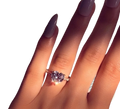 A sparkling heart shaped zircon engagement ring with white gold plating elegantly worn on a finger