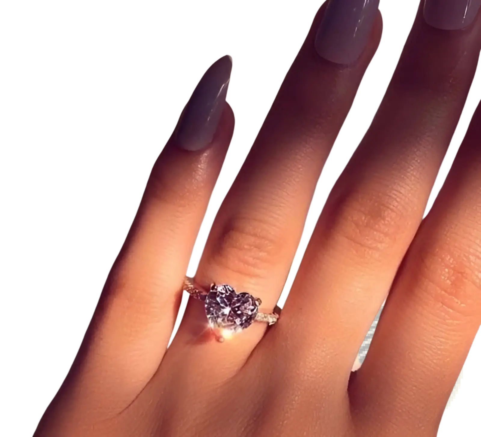 A sparkling heart shaped zircon engagement ring with white gold plating elegantly worn on a finger