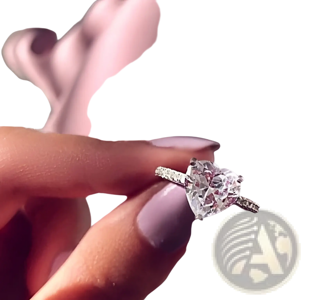 A heart shaped zircon engagement ring in white gold plating with a sparkling pave set band held between fingers