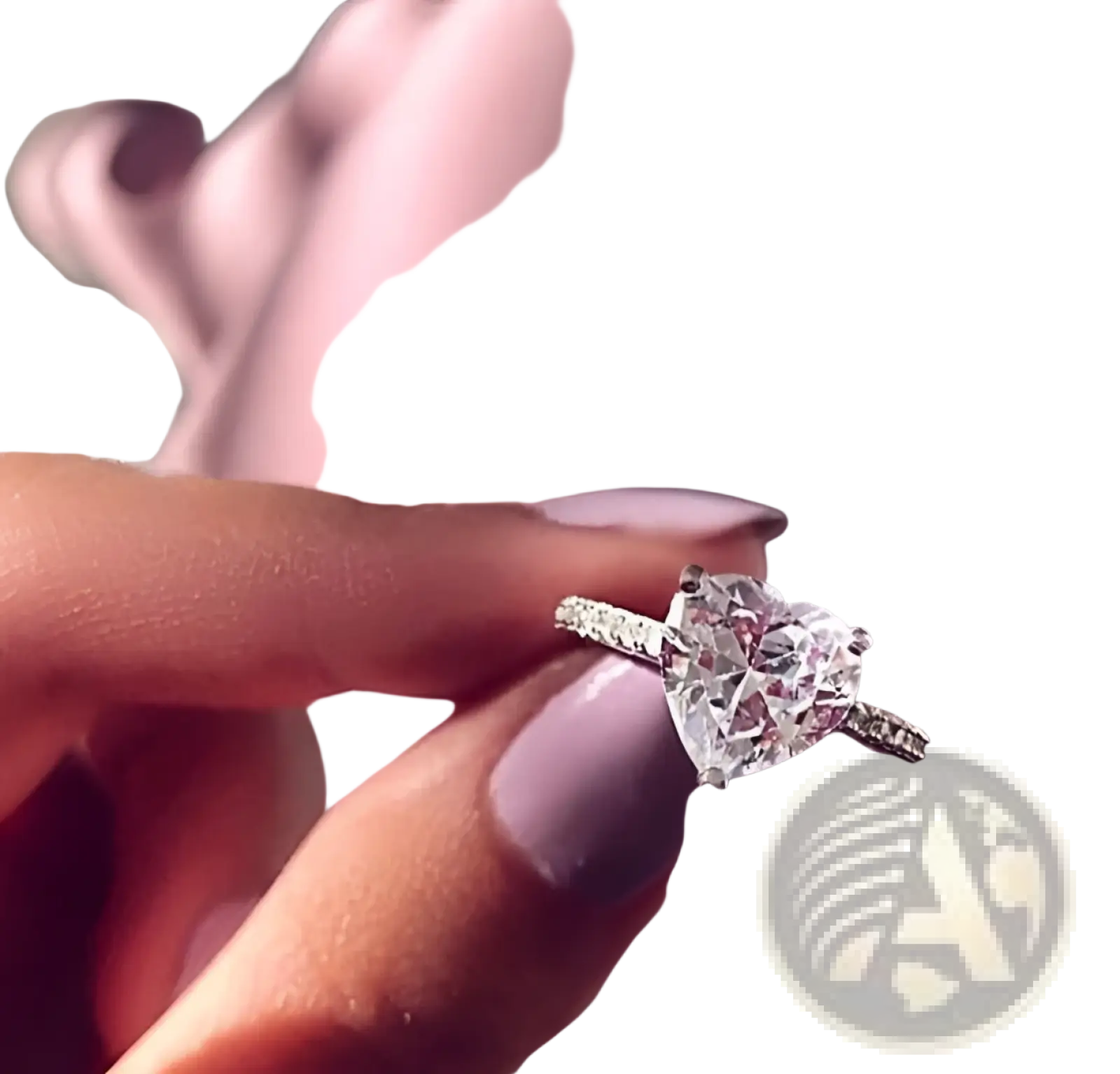 A heart shaped zircon engagement ring in white gold plating with a sparkling pave set band held between fingers