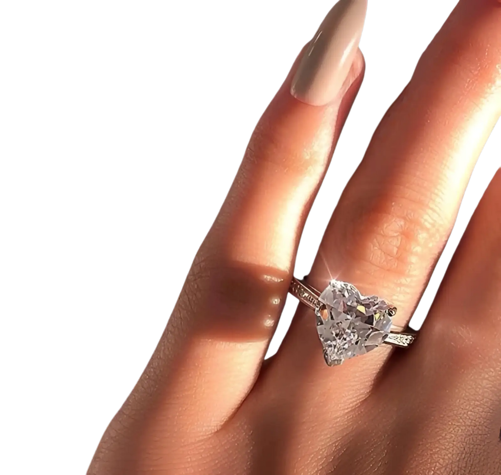 A heart shaped zircon engagement ring with a sparkling diamond in white gold plating and smaller side diamonds