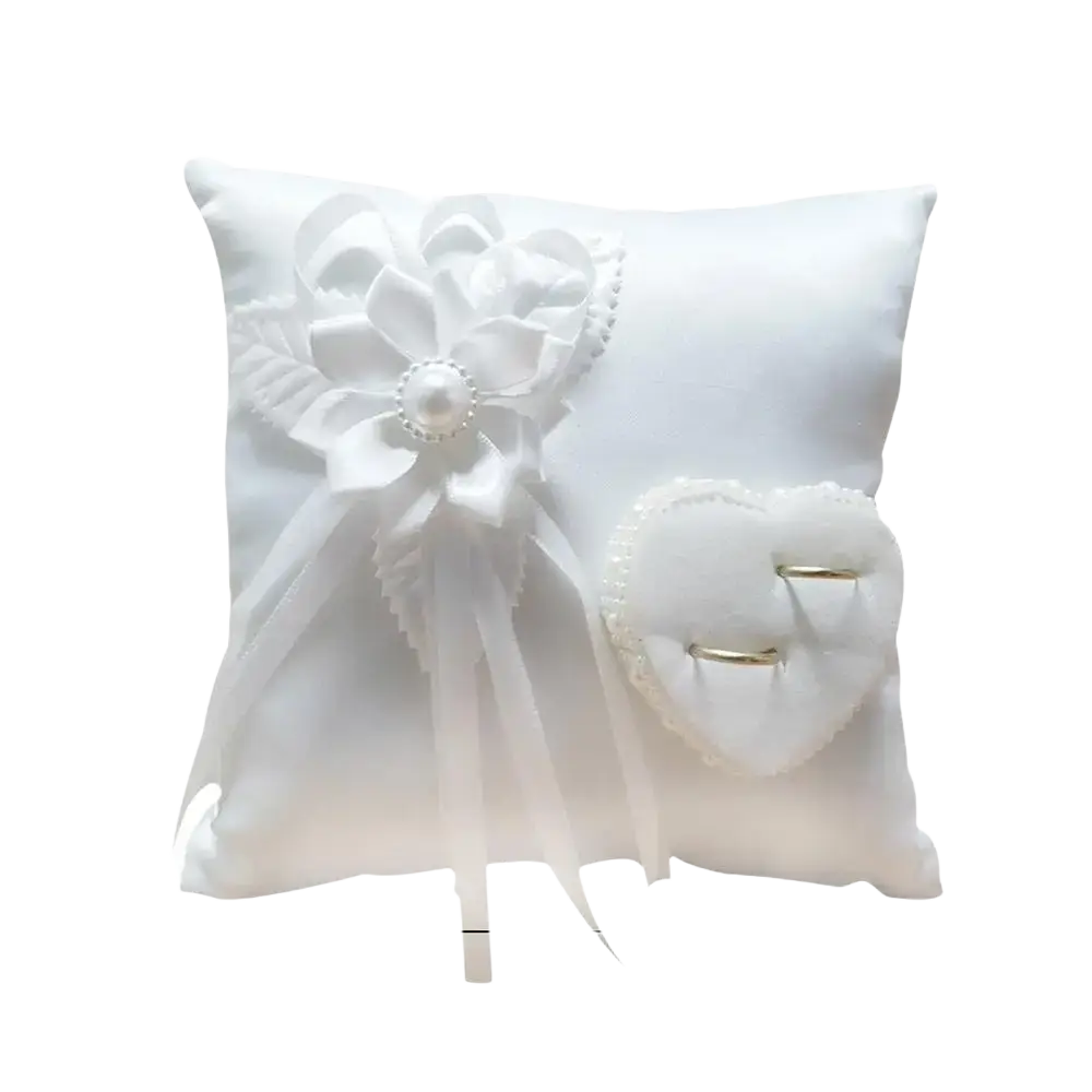 Heart wedding ring pillow in white satin with a large floral bow and heart shaped ring holder for bridal ceremony