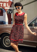 A sleeveless black cotton dress with red peter pan collar trim and small red heart pattern called retro hearts