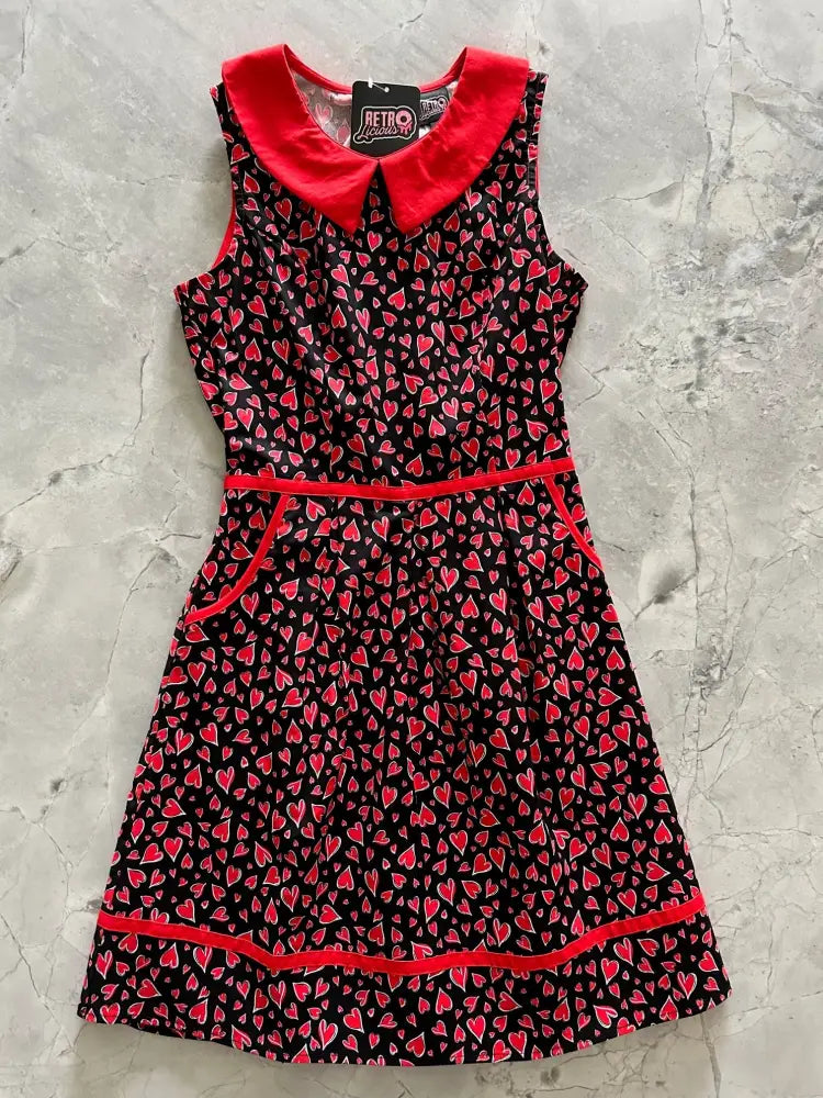 Black sleeveless cotton dress with red peter pan collar and trims featuring pink heart pattern retro hearts design