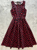 Black sleeveless vintage style cotton midi dress with flared skirt red heart pattern and fitted waistband with pockets