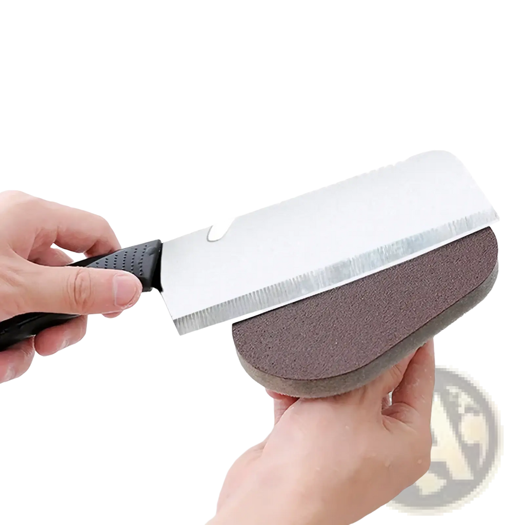 Black-handled kitchen knife being sharpened on dual-sided abrasive stone alongside heavy duty pot scraper sponge with handle