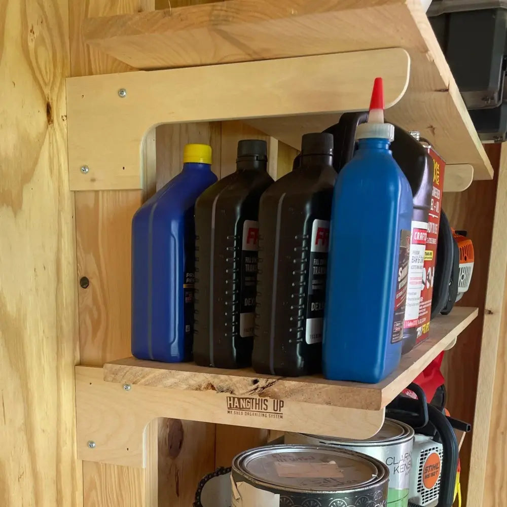 Blue plastic bottle with red nozzle and white cap standing on heavy duty wooden shed shelf bracket kit