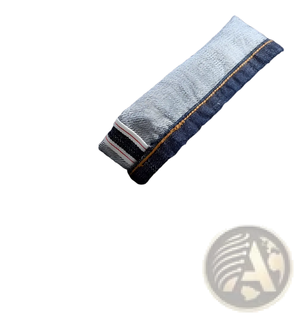 Heavyweight red selvedge dark blue denim jeans with rolled cuff showing lighter fabric and striped stitching detail