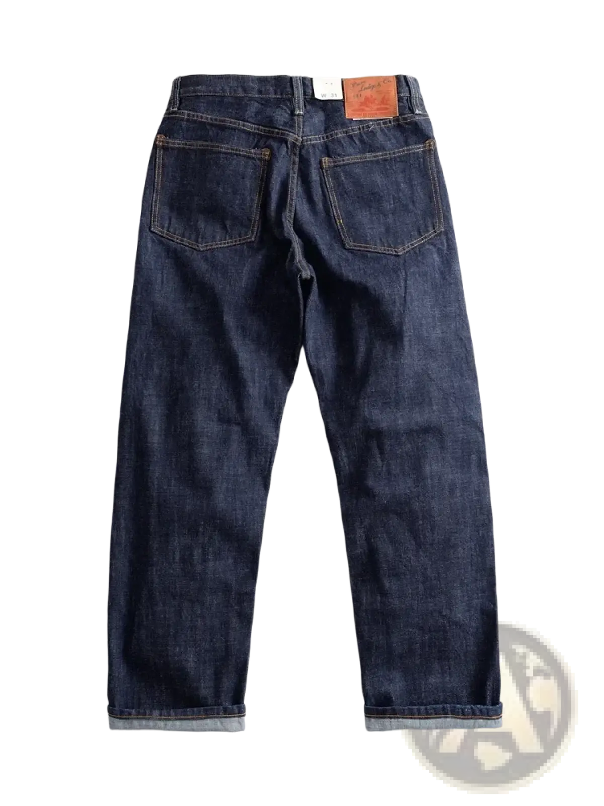 Dark indigo heavyweight red selvedge denim jeans with classic five-pocket design and rolled cuffs