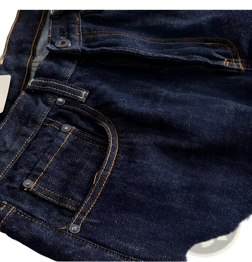 Heavyweight red selvedge denim jeans in dark indigo with contrasting tan stitching and silver metal buttons