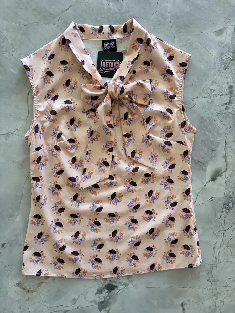 Beige cotton vintage hedgehog print sleeveless blouse with purple orange floral pattern and fabric bow at neckline