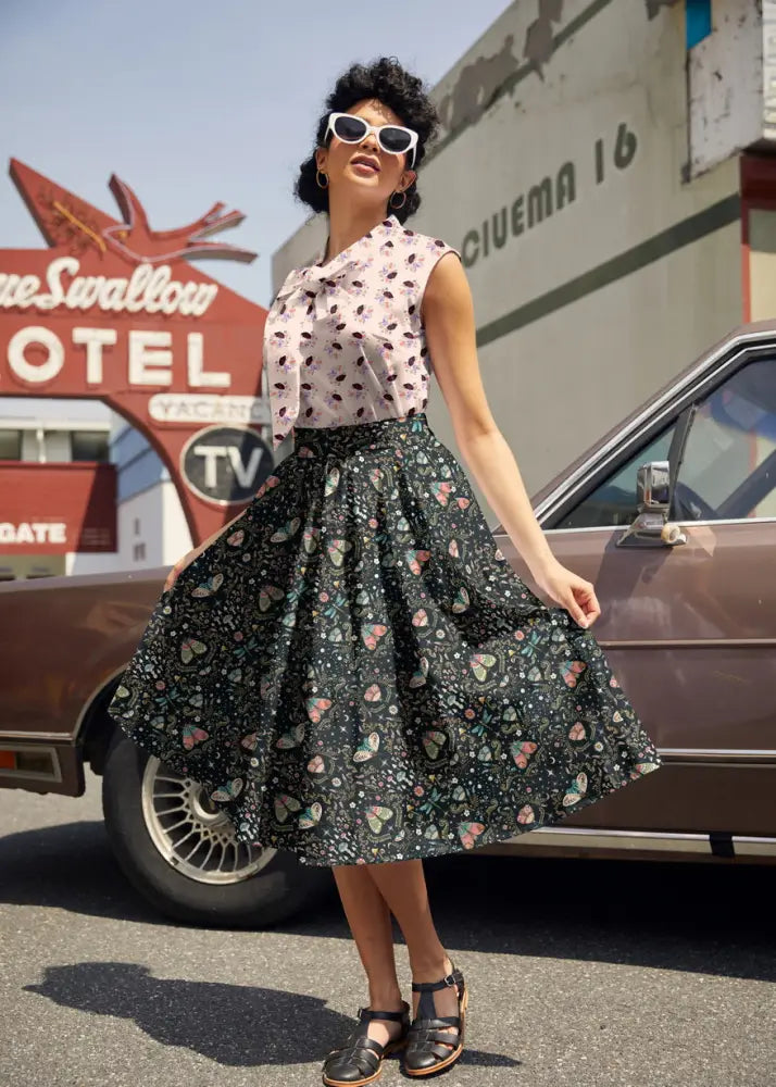 Black a-line skirt with pastel heart and dot pattern made from lightweight fabric paired with vintage hedgehog print cotton bow blouse
