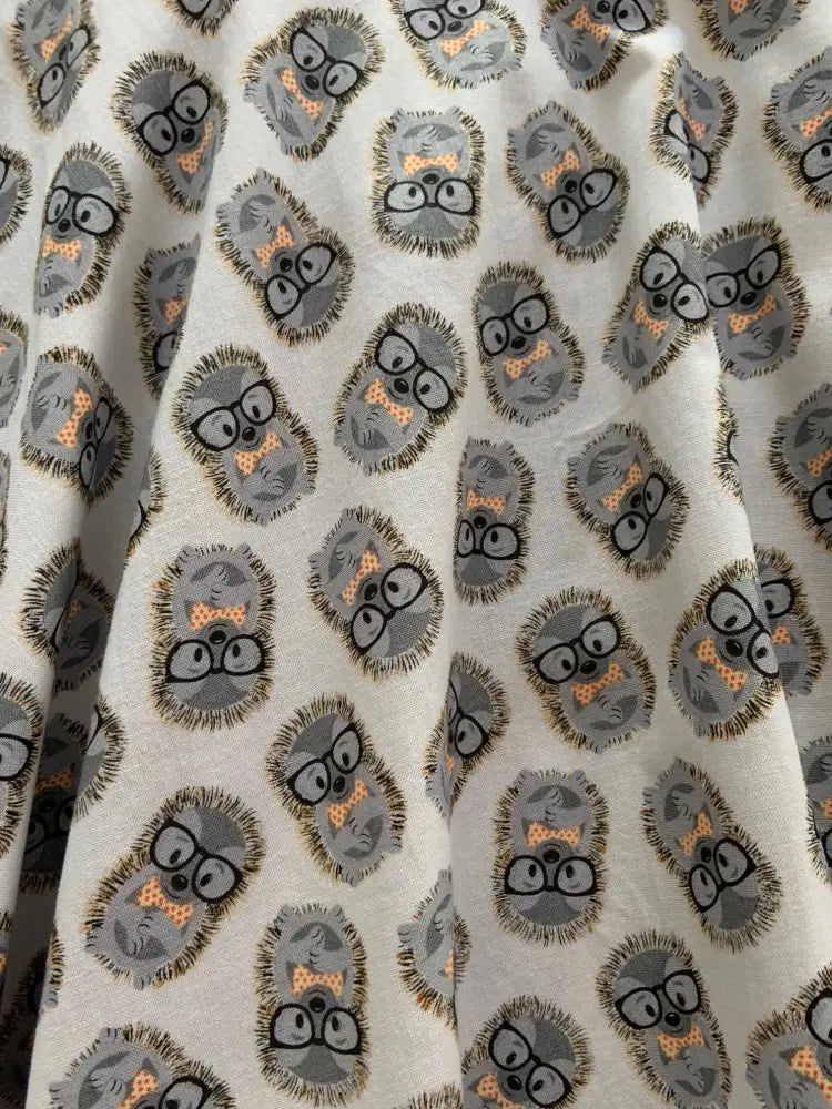 White cotton skater skirt with a retro hedgehog print featuring gray cartoon hedgehogs wearing glasses and bow ties