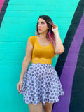 Retro hedgehog print cotton skater skirt in white with black skull pattern paired with mustard yellow top