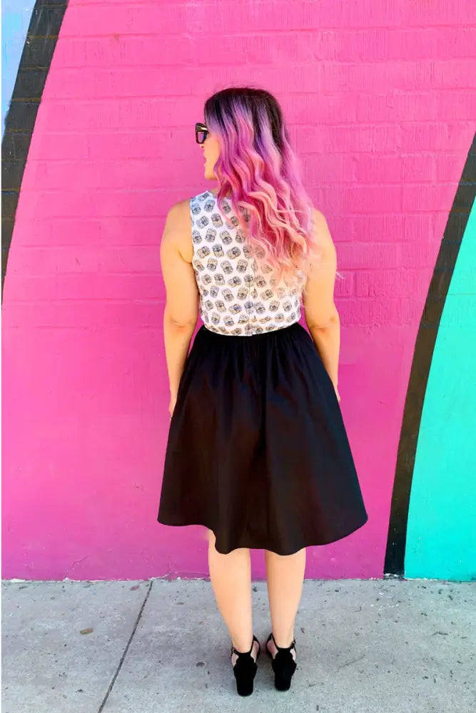 Black cotton a-line skirt with fitted waist and flared hem as part of vintage hedgehog print twofer dress with pockets