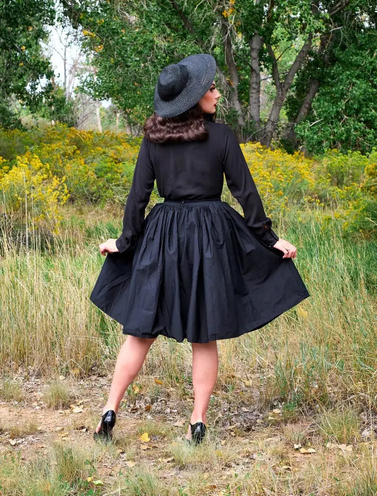 Black wide brimmed straw hat with textured woven pattern and slightly curved crown featured with helen retro black bow tie blouse