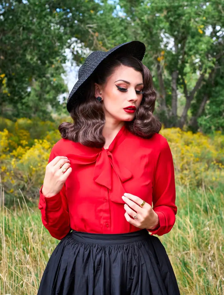 A vibrant red long-sleeved plus size blouse with a prominent bow tie neckline for retro style looks