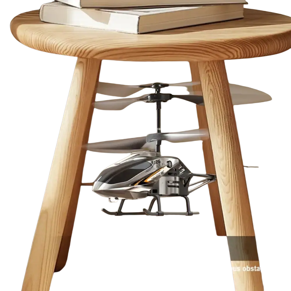 Silver and black metal alloy helicopter toy with gold accents usb charging socket hovering beneath wooden table