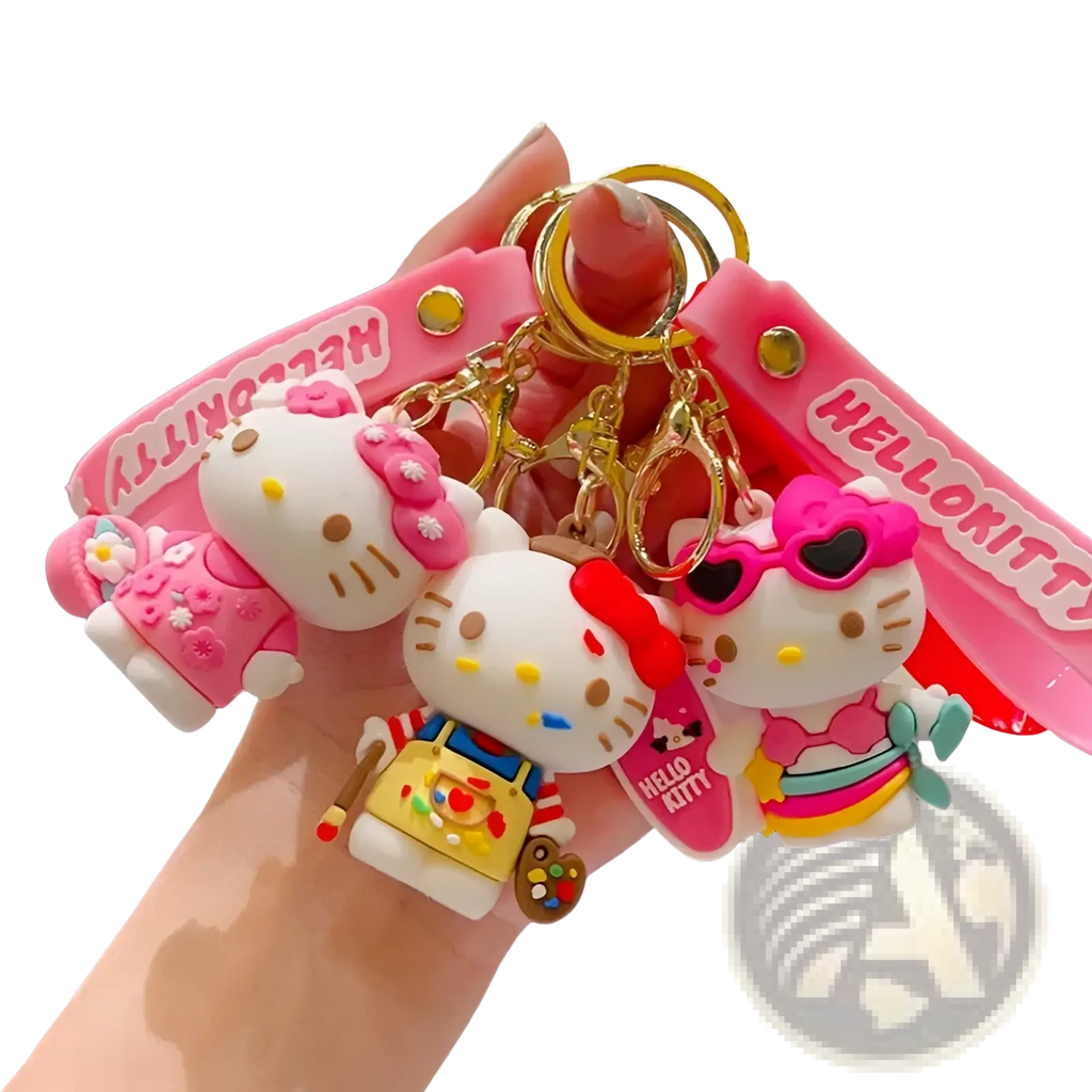 A set of three pink and white hello kitty cartoon keychains with unique outfits like painter apron and sunglasses