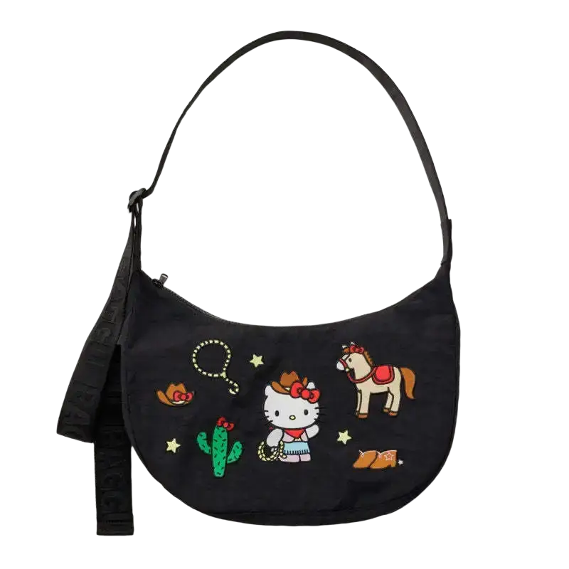 Black hello kitty dumpling crossbody bag with embroidered cowboy-themed appliqués including cactus horse and boots