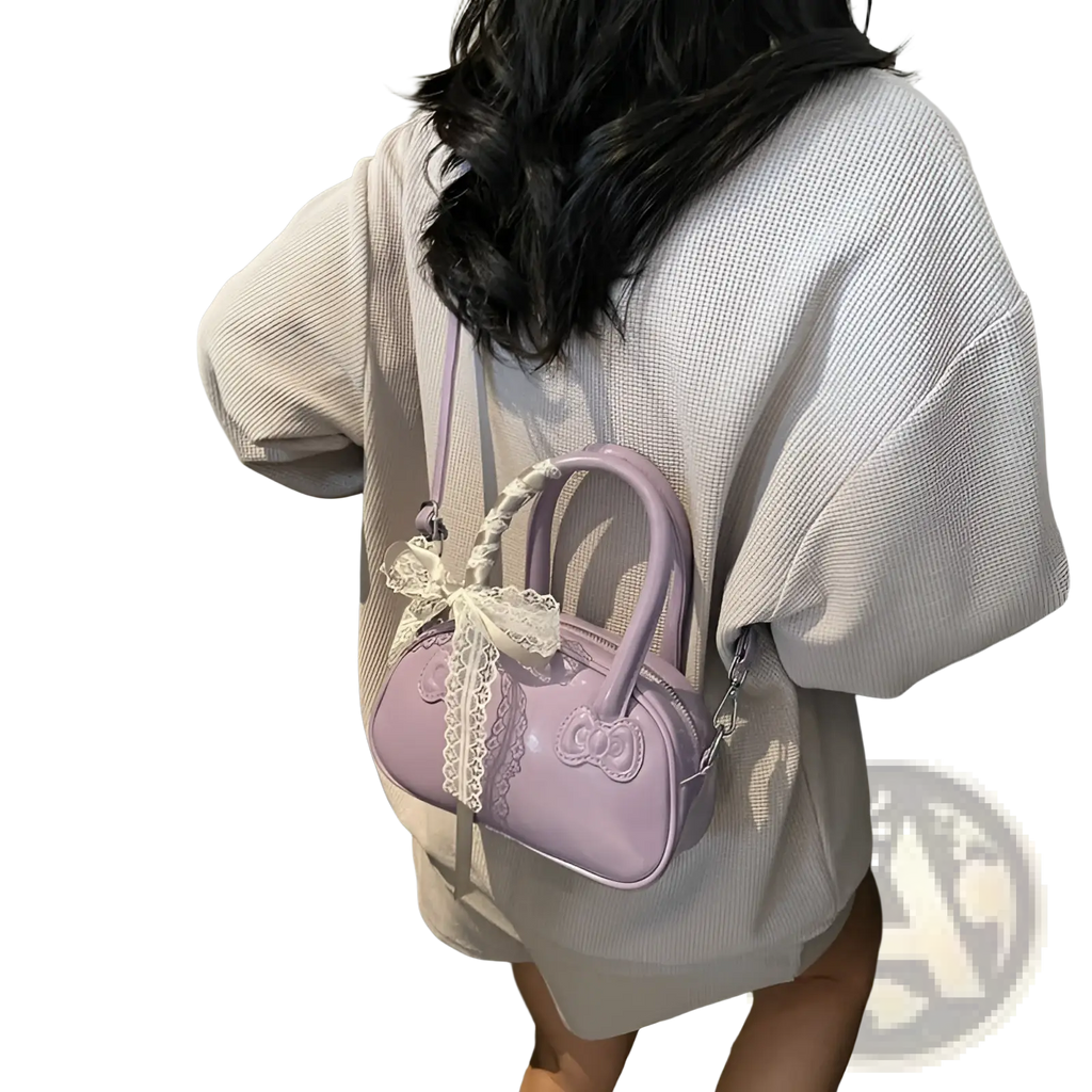 Lavender glossy plastic hello kitty crossbody bag with bow and lace trim featuring a stylish feminine design
