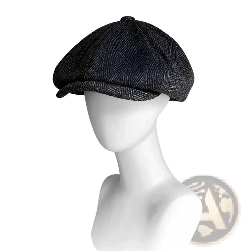 A dark gray herringbone woolen octagonal flat cap with eight-panel design and a slightly curved brim