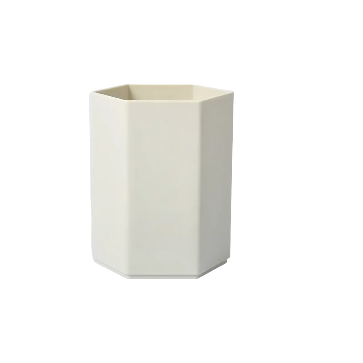 Cream-colored hexagonal plastic toothbrush holder suitable for organizing pens and desk accessories