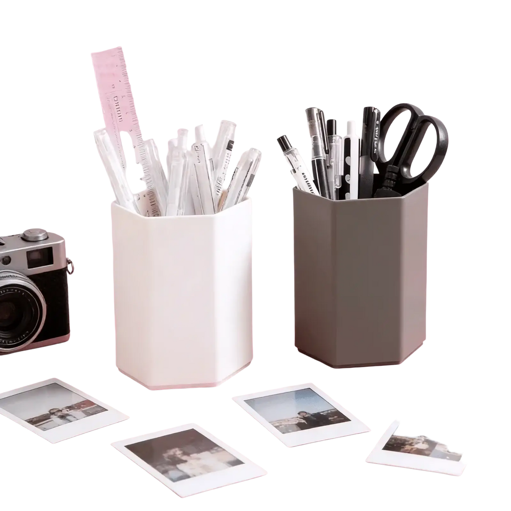 White hexagonal plastic pen holder desk organizer filled with pens and a ruler for efficient desk storage