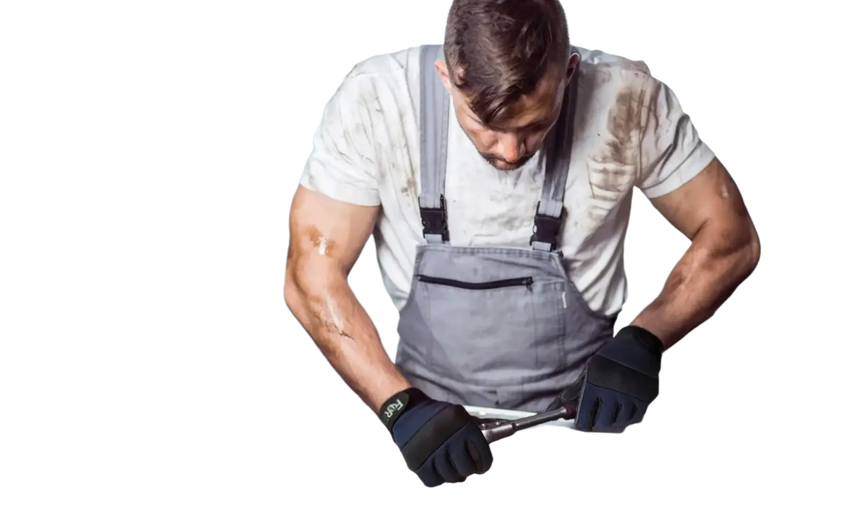 A mechanic wearing black high dexterity touch screen work gloves in gray overalls working on a car engine
