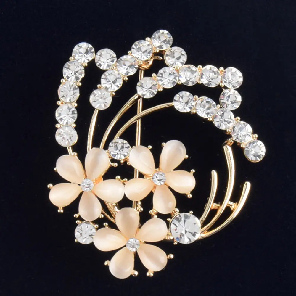 Vintage opal and rose gold floral bridal brooch with peach blossoms and clear crystal centers accented by rhinestones
