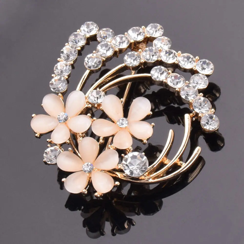 Vintage opal and rose gold floral bridal brooch with delicate gold tone, pale peach enamel flowers, and sparkling rhinestones