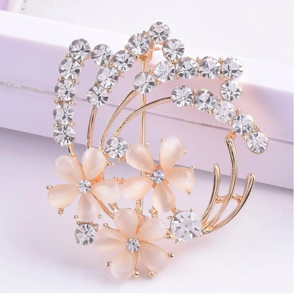 Vintage opal and rose gold floral bridal brooch with delicate peach resin flowers and clear crystal accents
