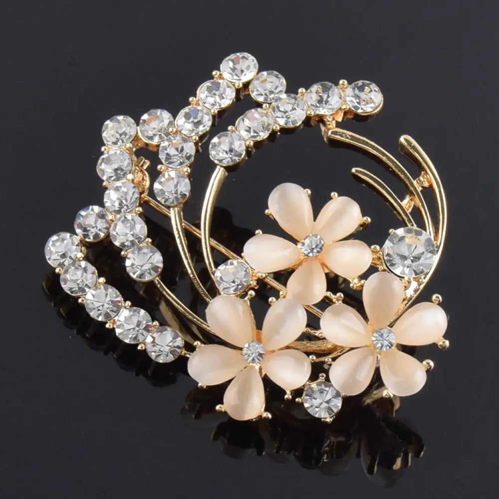 Vintage opal and rose gold floral bridal brooch with gold-toned delicate peach petals and clear rhinestones swirl design