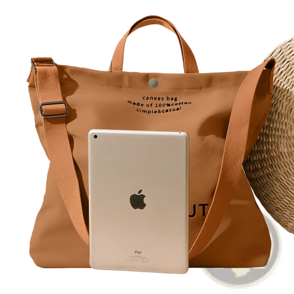 A tan high end large capacity canvas tote bag made of 100 percent cotton with matching handles and detachable strap